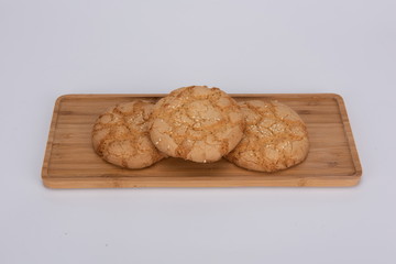 Small walnut cookies made from walnuts are placed on a wooden tray