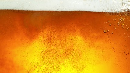 Super slow motion of macro shot of beer drink, close-up. Filmed on high speed cinema camera, 500 fps. - Powered by Adobe