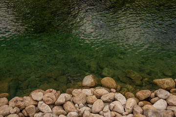 many stones and  clear water