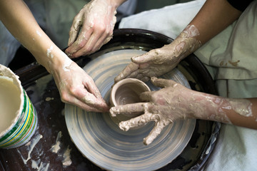 Peoples working with clay together.