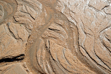 Natural sand patterns in beach at low tide..