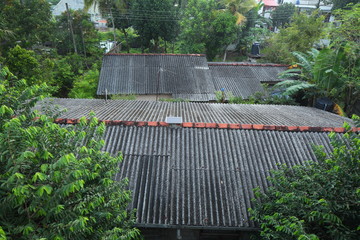 Solar panels on the roof of a tropical city house early in the morning at dawn.