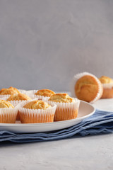 Delicate and delicious lemon cupcakes with crisp on a white plate