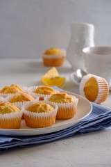 Delicate and delicious lemon cupcakes with crisp on a white plate