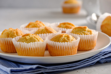 Delicate and delicious lemon cupcakes with crisp on a white plate