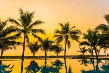 Fototapeta na wymiar Beautiful nature with palm tree around outdoor swimming pool in hotel resort nearly sea ocean beach