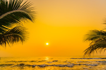 Obraz na płótnie Canvas Beautiful nature with palm tree around sea ocean beach at sunset or sunrise