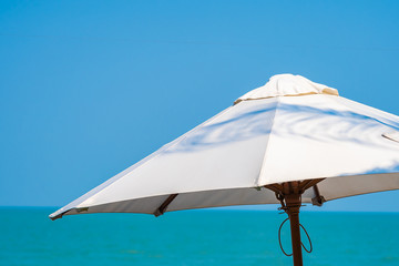 White umbrella around beautiful tropican nature of beach sea ocean