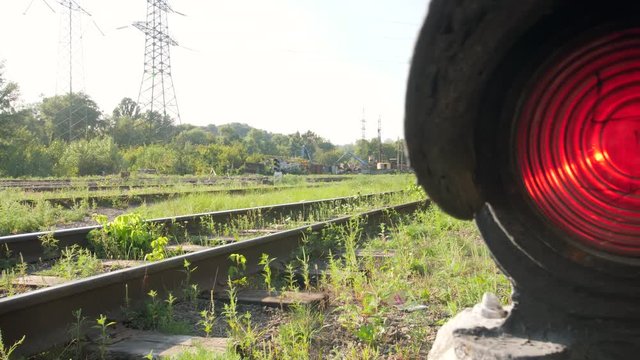4k dolly video of old semaphore glowing red light on railroad cargo station