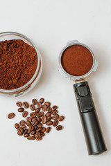 coffee horn with natural ground coffee and ground coffee in a glass jar, top view