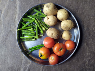 some eatable vegetable put in a steel plate on stone background