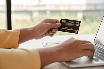 Young lady use credit cards and laptops for online shopping and making payments the internet