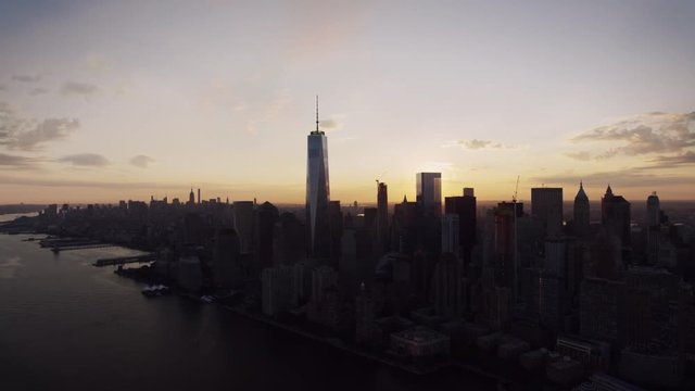 New York City modern skyline cityscape silhouette in warm evening orange sunset in amazing drone aerial panorama flyover