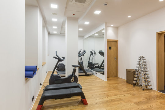 Interior of a small hotel gym with equipment