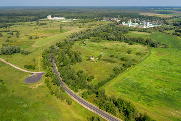 Fototapeta premium Aerial view of countryside, highway, the country road and fields in the agricultural area