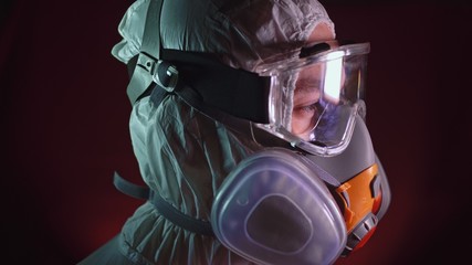 Man in protective costume suit, gas protect medical spray paint mask. Doctor in respirator. Concept...