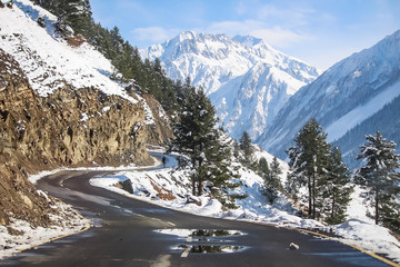 A curvy road passing through snow covered mountains of Himalayas at Drass. Srinagar-Leh Highway. BEACON. BRO. NHAI