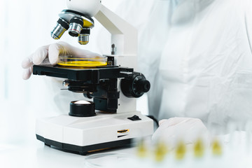 Close up of male hands that touching microscope