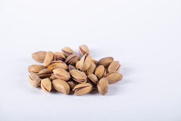 Pistachios on the center of a white background