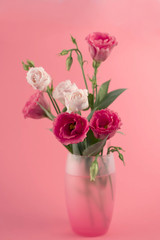 Fototapeta na wymiar bunch of white and pink eustoma flowers in glass vase