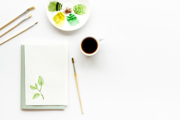 Painting herbs. Brushes and picture on white background top-down copy space