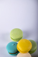 Colorful macarons isolated on white on the bottom side