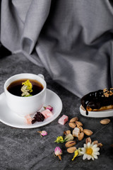 A cup of tea with Turkish lokum, pistachios and chocolate pie