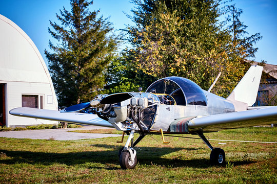 Lightweight single-engine aircraft ready for engine maintenance.