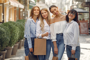 Beautiful girls in a summer city. Ladies with shopping bags