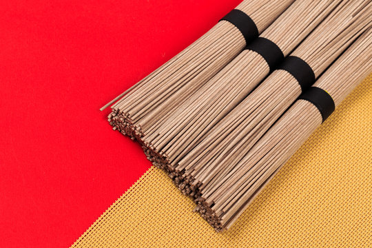 Dried Organic Buckwheat Soba Noodles Ready to Cook on red background  - Image