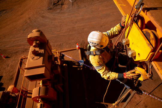 Rope Access Maintenance Worker Wearing Safety Harness Hard Hat Working At Height Descending On Rope Performing Inspecting Lifting Chain Block On Beam Clamp Trolley Prior To Use Construction Site Perth