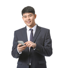 Young Asian businessman with mobile phone on white background