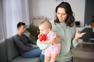 Young woman suffering from postnatal depression at home