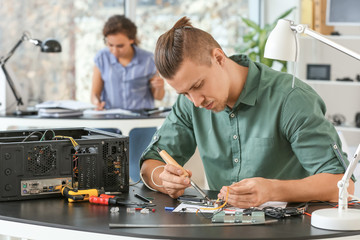 Electronic technician working in service center