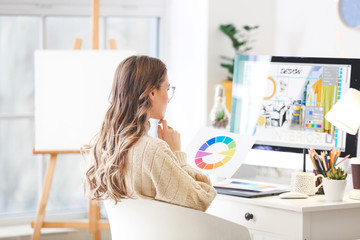 Female interior designer working in office