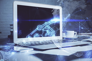 Computer on desktop in office with technology theme hologram. Multi exposure. Tech concept.