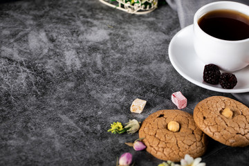 Obraz na płótnie Canvas A cup of tea with almond cookies on the marble