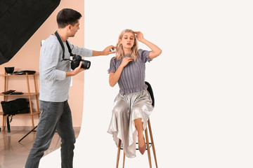 Professional photographer working with model in studio