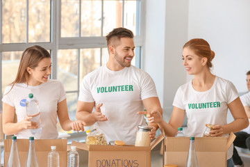 Team of volunteers with products indoors