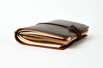 Handmade paper diary notebook in brown leather cover, close-up.