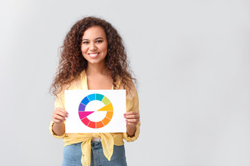 African-American woman with color palette on grey background