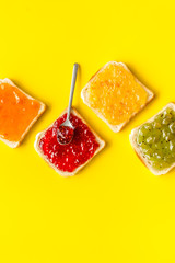 Toast with jam. Colorful set on yellow background top-down copy space
