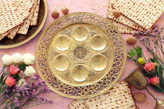 Pesah celebration concept (jewish Passover holiday). Traditional pesah plate text in hebrew: Passover, horseradish, celery, egg, bone, maror, charoset