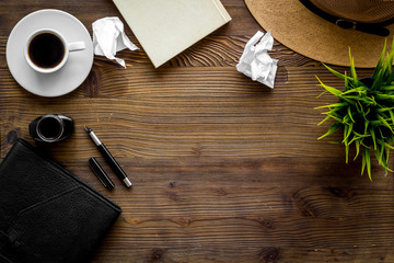 Writer's block concept. Notebook, pen, crumpled paper on dark wooden background top-down copy space