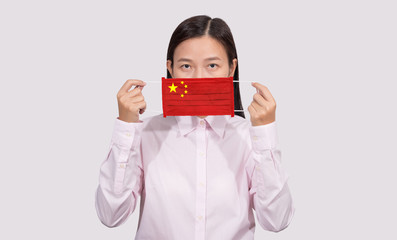 Asian woman wearing hygienic mask painting china flag to protect from the Coronavirus 2019 (COVID-19) infection outbreak situation, the virus originated from Wuhan, China.