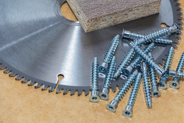 Screws, confirmations for furniture, are on the table. Furniture production.