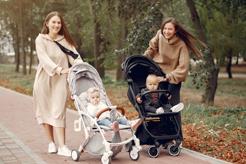 Fototapeta premium Mothers with children. Women use the carriages.