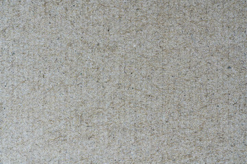 Light brown background from sheet of recycled cardboard. Close-up detail view of abstract texture recycled eco-friendly material pattern background.