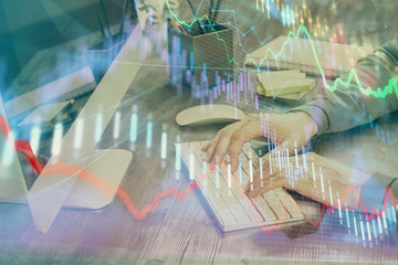 Double exposure of financial graph with man works in office on background. Concept of analysis.