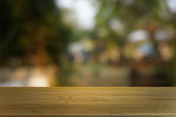 Empty dark wooden table in front of abstract blurred bokeh background of restaurant . can be used for display or montage your products.Mock up for space.